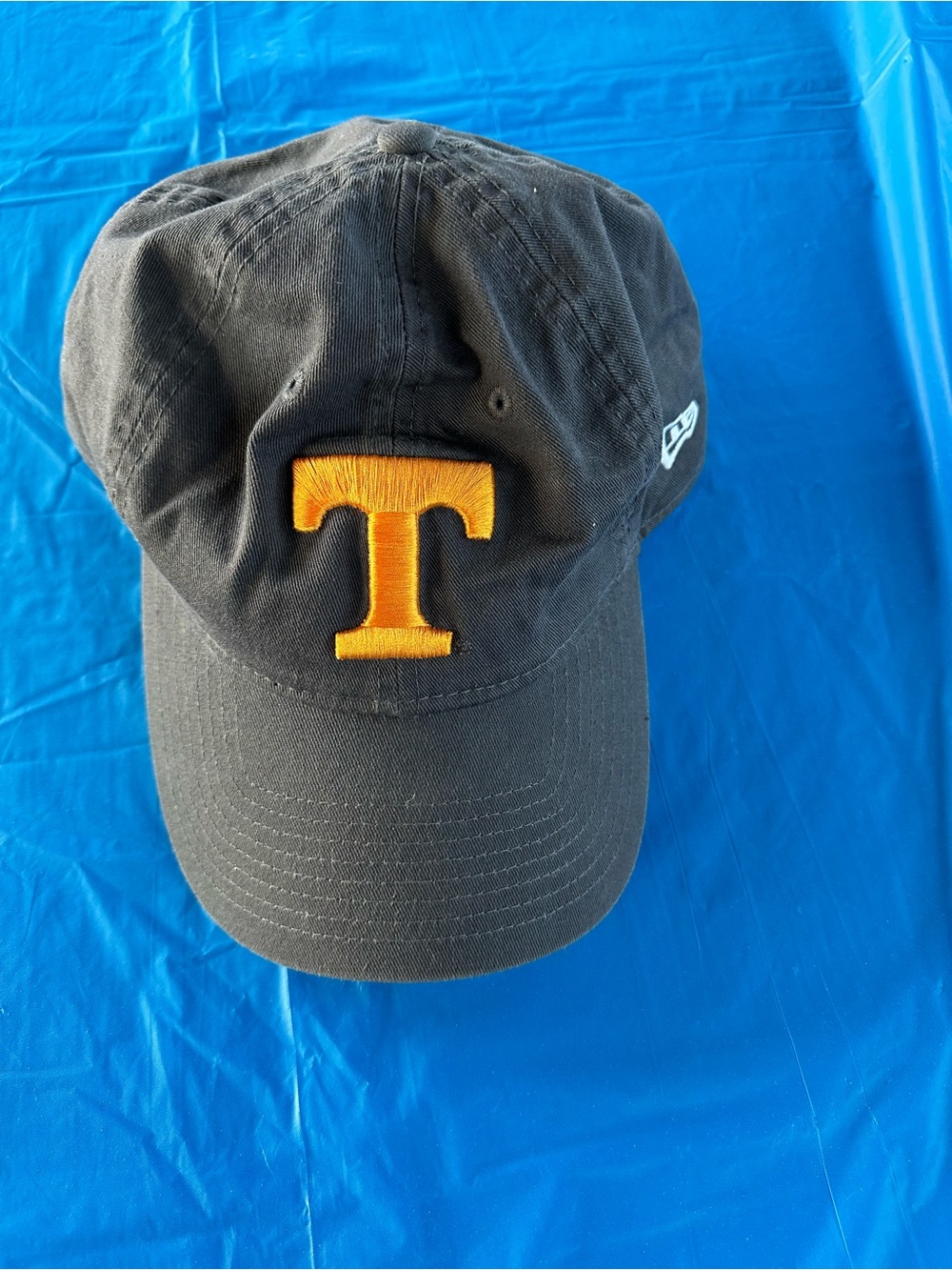 New Era Black Hat with Orange Embroidered 'T'